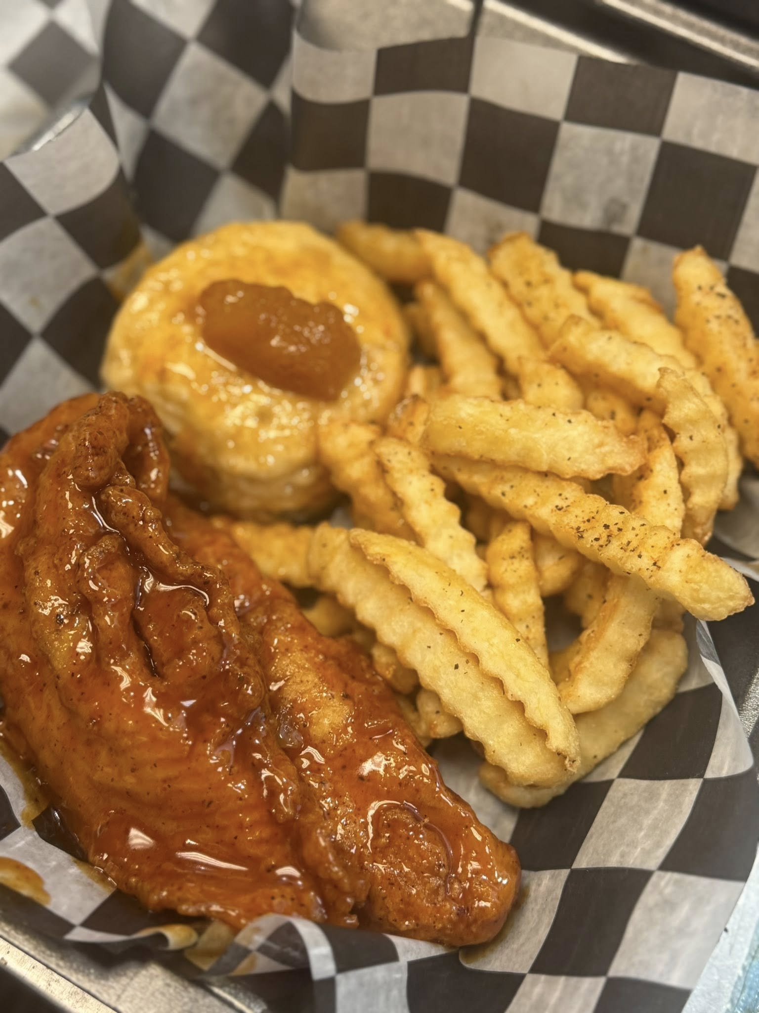 Fried chicken leg, biscuit, and sweet potato fries at Gladys' Grille