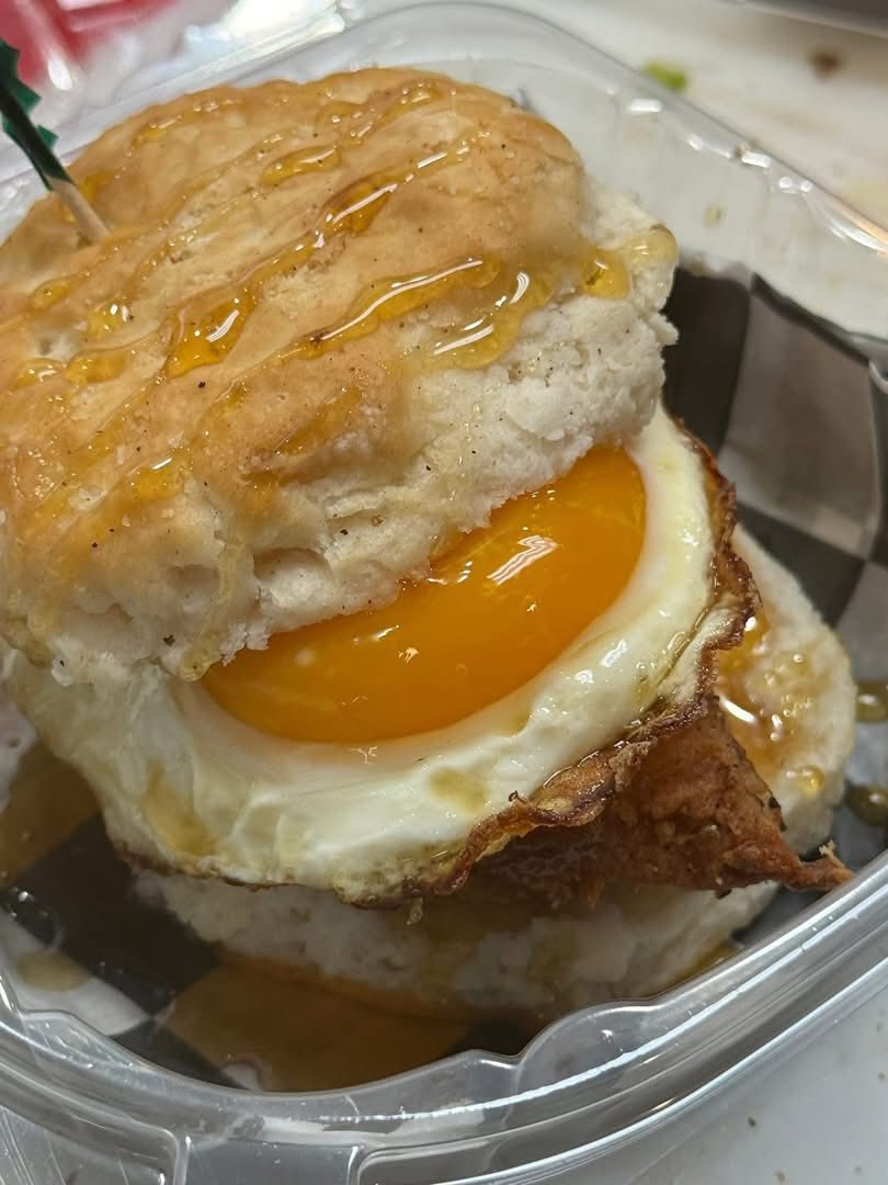 Fried chicken sandwich with honey and egg on brioche