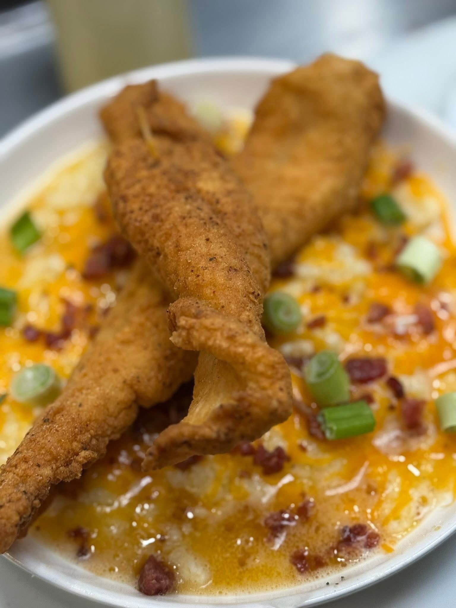 Fried chicken leg over creamy mac and cheese at Gladys' Grille