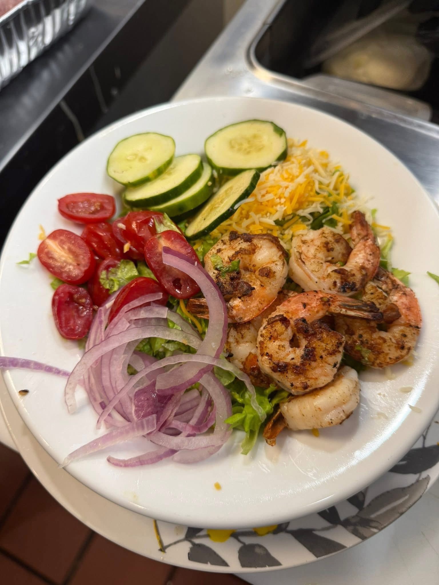 Seasoned shrimp with fresh vegetables at Gladys' Grille