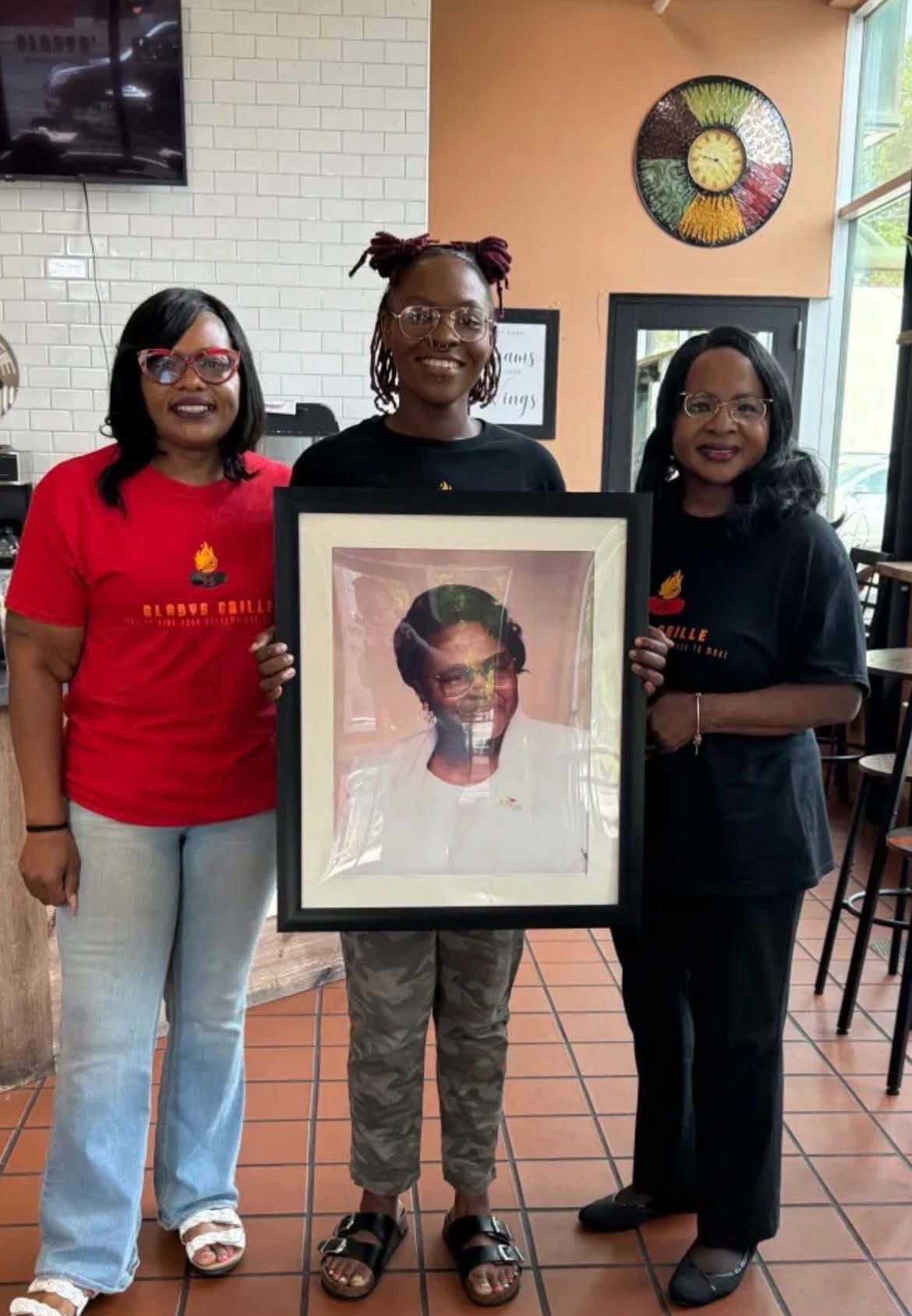Titiana Oliver and team with portrait of Grandma Gladys